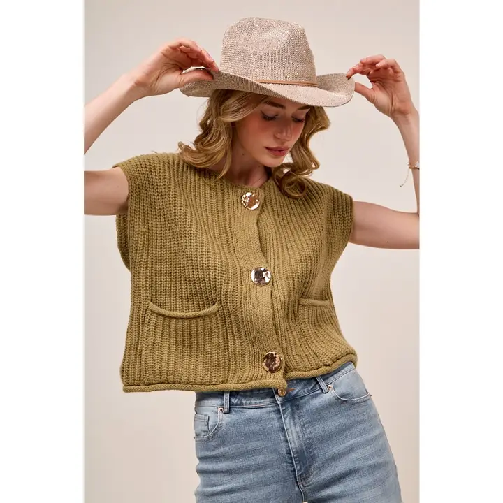 Model styling a knit vest with jeans