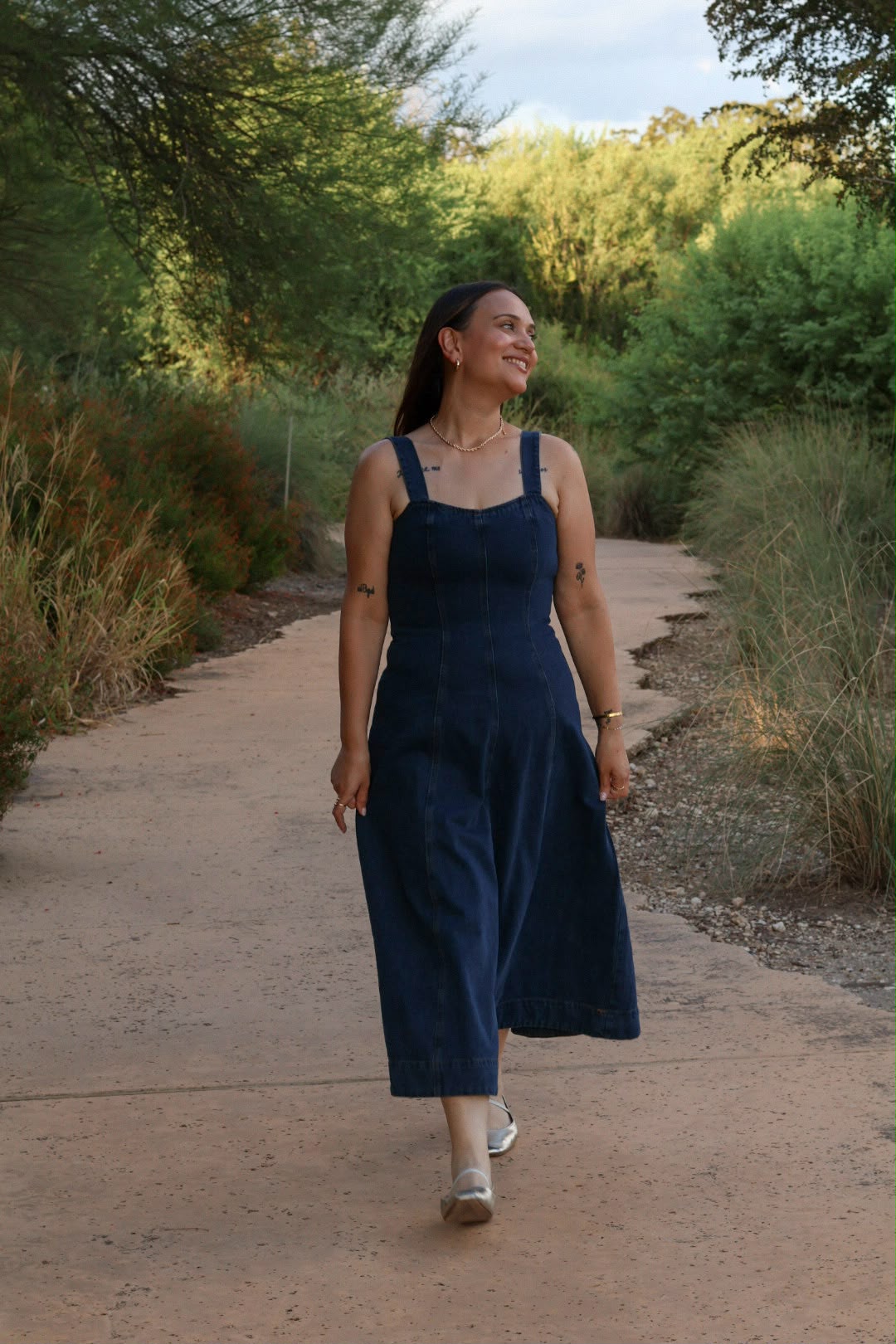 Carolina in the Denim Midi Dress, walking outdoors at golden hour